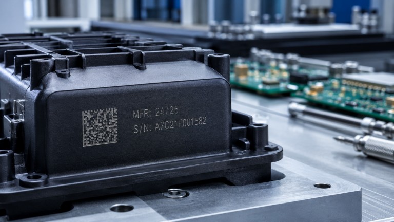 CO2 laser engraving serial number and Data Matrix traceability code on black plastic electronic housing and PCB label in electronics manufacturing